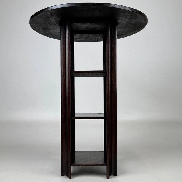 A distinctive early 20th-century English side table, finely crafted from oak and distinguished by its unusual combination...