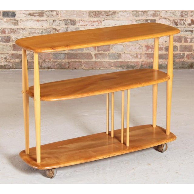 Mid Century Ercol Windsor Trolley Bookcase (model 361) 'Baby Giraffe' in solid elm and beech, circa 1960s. Blue label...