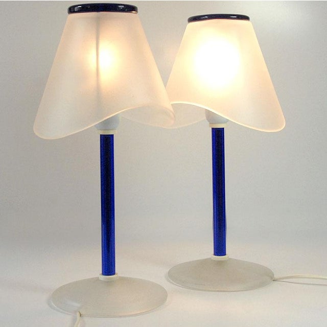 A pair of highly decorative table lamps crafted from satin Murano glass. They combine matte white with a rich sapphire...