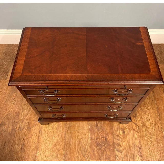 A Georgian-style pair of mahogany slide-top Bachelor chests of drawers The chest features a pull-out brushing / writing...