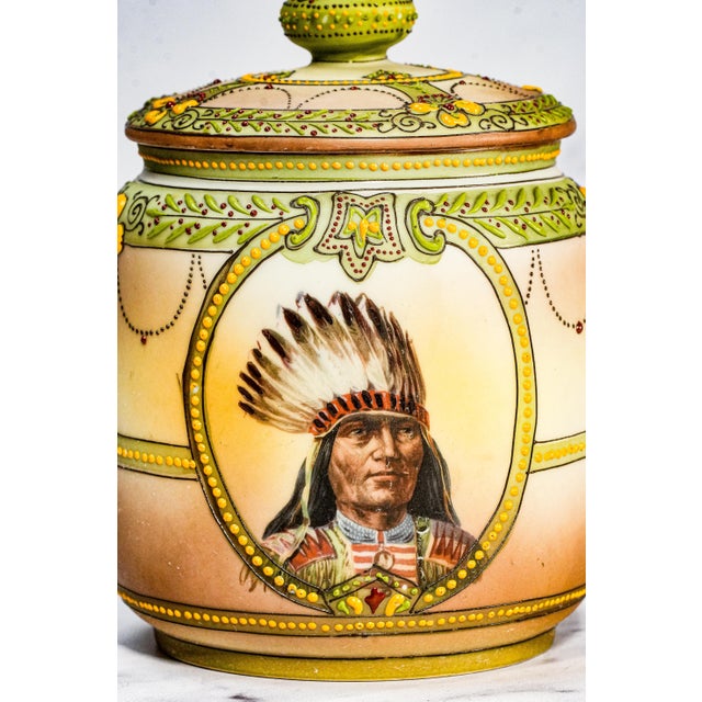 A truly exceptional and seldom-seen treasure, this circa 1915 Nippon hand-painted porcelain tobacco humidor embodies the...