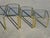 Set of 3 nesting tables in gold-tone metal and glass. Gold-tone metal frame in a tubular shape. 5 mm thick tempered glass...
