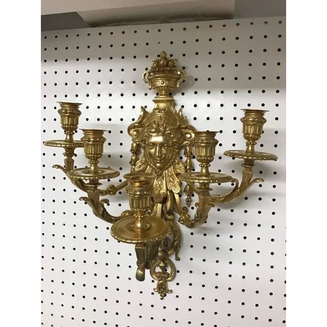 Stunning pair of five-light brass candelabra sconces. Depicting a "Medusa face" with beautiful scroll work.