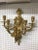 Stunning pair of five-light brass candelabra sconces. Depicting a "Medusa face" with beautiful scroll work.