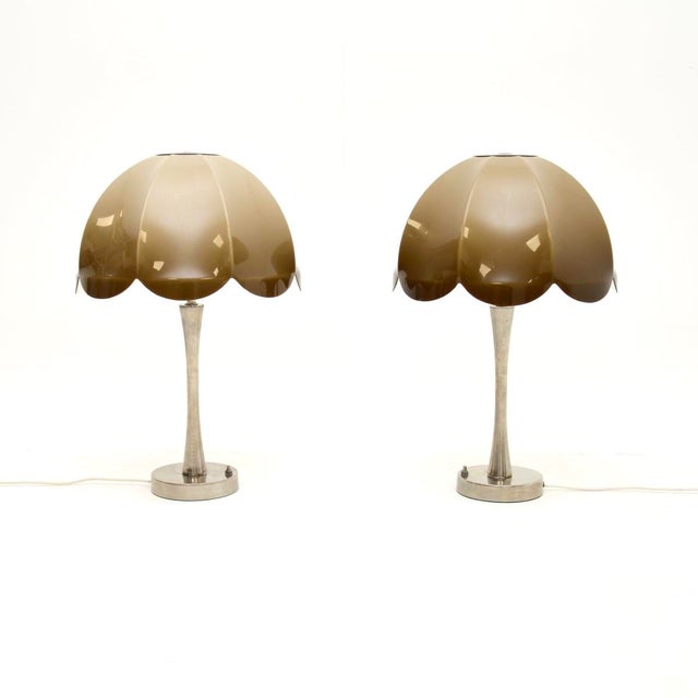 A stylish, unusual and beautifully designed pair of vintage chrome and acrylic table lamps. They were likely made in...