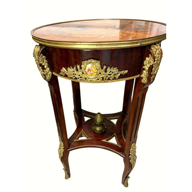 An elegant matched pair of early 20th-century Louis XV Revival salon or occasional tables, circa 1900–1920. Each table...