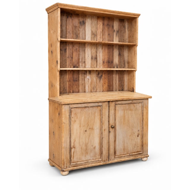 A characterful late 19th to early 20th century pine kitchen dresser, combining generous open shelving with a useful two-...