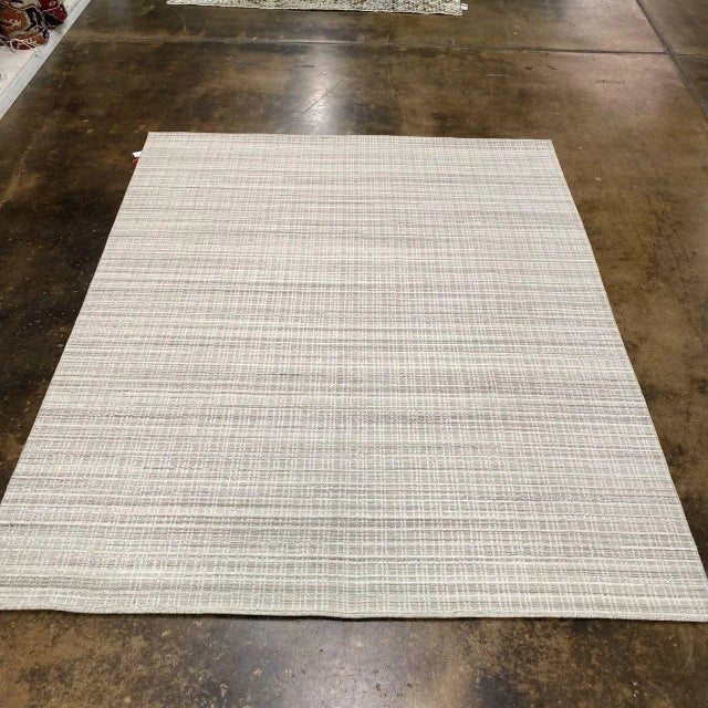 ACTUAL SIZE: 8'2" X 10'1" PRIMARY COLOR: Ivory / Gray AGE: New ORIGIN: India MATERIALS: Wool FOUNDATION: Cotton...