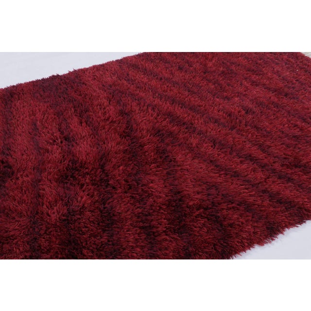 Hand-knotted in lush, high-pile wool in Sweden circa 1960-1970, this 5x8 vintage Swedish Rya rug is a bold new addition to...