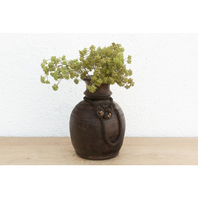 Originally used in village homes for storing milk, ghee, or grains, this antique wooden pot has survived generations of...