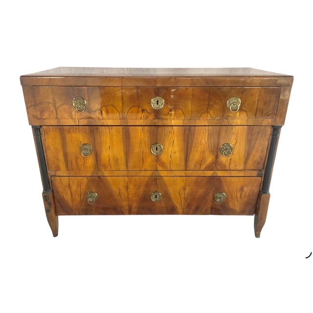 German Biedermeier Walnut Chest of Drawers. Drawers feature elegant, ebonized flanking columns. The case contains three...