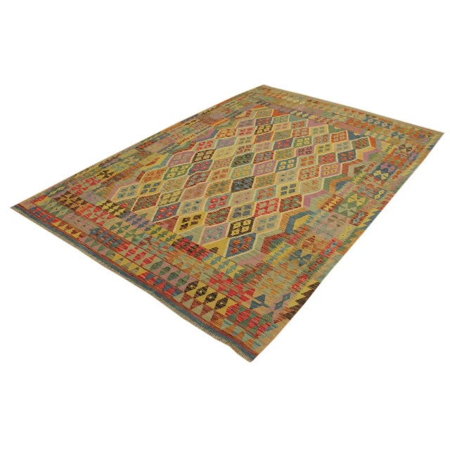 "Add a touch of elegance to your home with this casual chic hand woven Tribal Kilim wool rug. Constructed on a loom by...