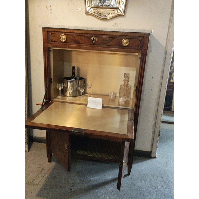 A rare c.1780 French Louis XVI secretaire, thoughtfully converted into a bar, the perfect statement piece for an entry,...