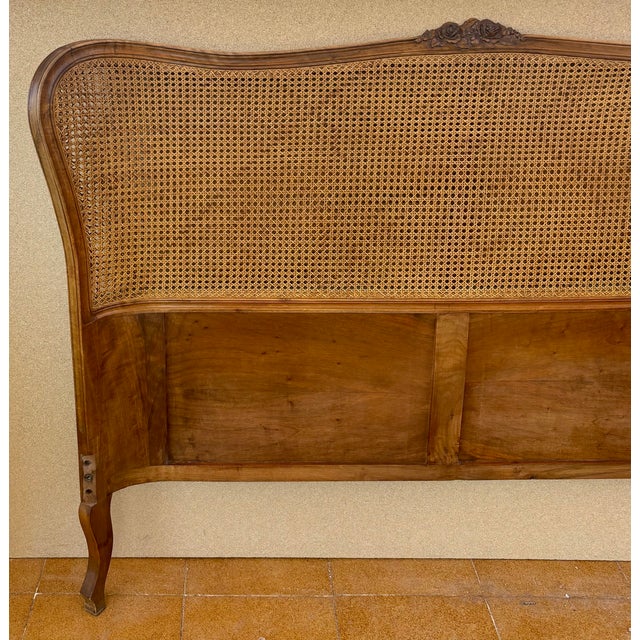 Elegant French Louis XV-style headboard crafted in walnut, featuring a beautifully curved silhouette and a decorative...