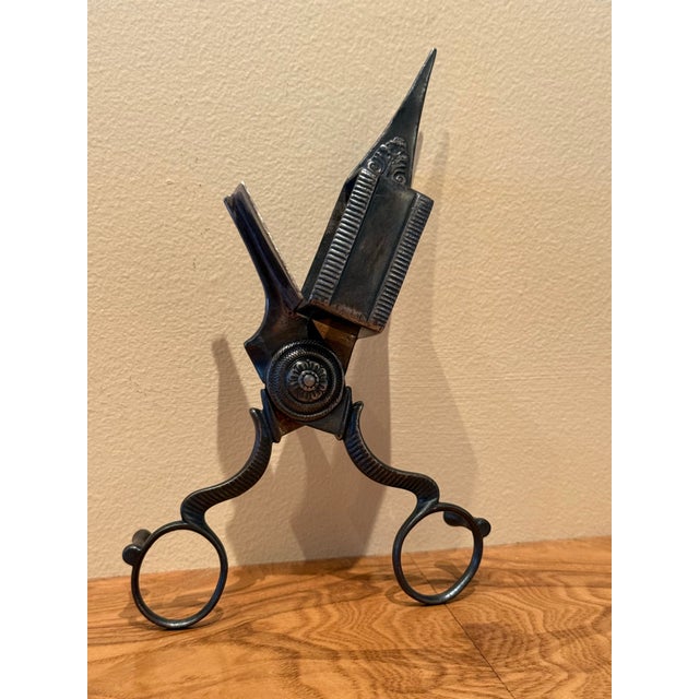 Elegantly detailed antique footed ornate candle snuffer scissors wick cutter trimmer is a vintage decorative piece that...