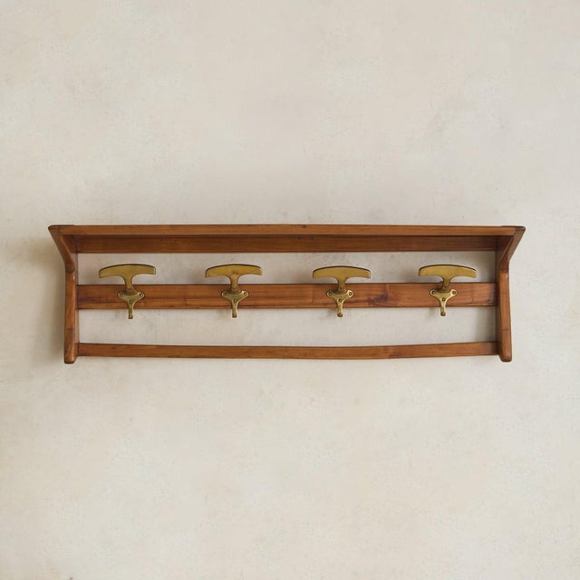 A Danish modern wall-mounted coat rack from the 1960s, where function is shaped with a quiet sense of intention. At just...