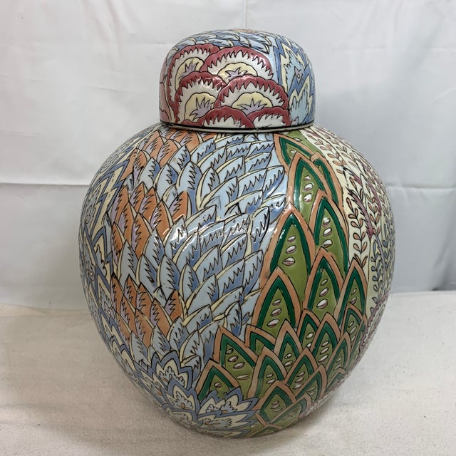 Offered here is a vintage pastel porcelain ginger jar featuring an abstract, geometric feather or peacock-like pattern.