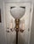 Vintage art deco style metal (brass?) torchière floor lamp with 3 candelabra arms and center frosted glass globe shade....