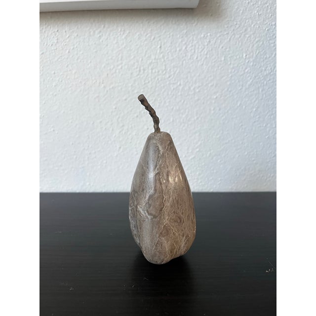 Mid century style smooth modern stone pear sculpture with a metal texture stem that goes through to the bottom.