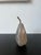 Mid century style smooth modern stone pear sculpture with a metal texture stem that goes through to the bottom.