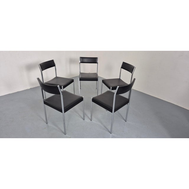 Set of 5 minimalist, chrome-plated chairs by Ernst Lauclair for Girsberger from the 1960s. Seats in black Skai...