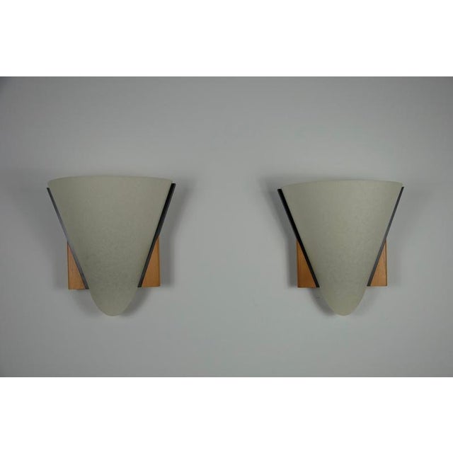 This beautiful pair of domus wall lamps from the 1970s combines natural materials with a timeless geometric design....