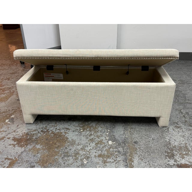 Design Plus Gallery presents an Upholstered Storage Bench from West Elm. The bench is upholstered in linen weave natural...