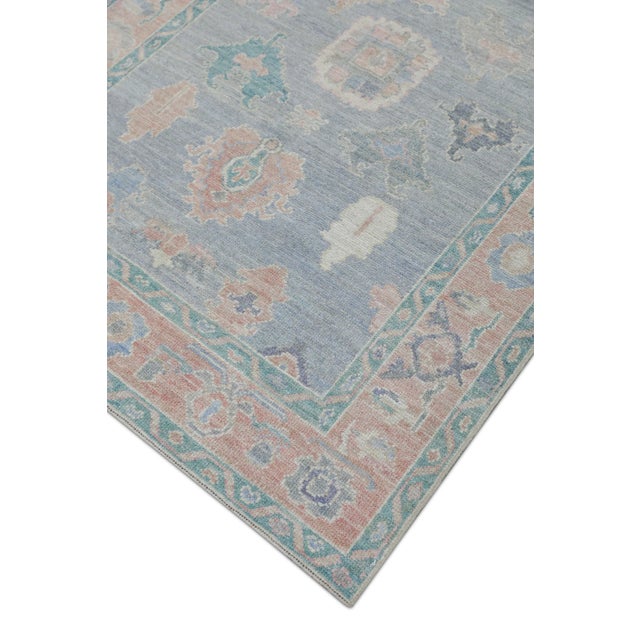 This modern Turkish Oushak rug is a stunning piece of art that has been handwoven using traditional techniques by skilled...