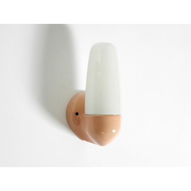 A rare mid-century modern glass and ceramic wall lamp. design by wilhelm wagenfeld. minimalist design in glass. Ceramic...