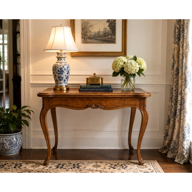 A beautifully crafted Baker Milling Road flip-top game table showcasing richly figured burl walnut veneers and graceful...