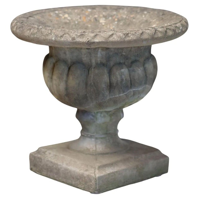 A fine English garden urn (or planter pot) on plinth of composition stone, featuring a round urn with a Classical...