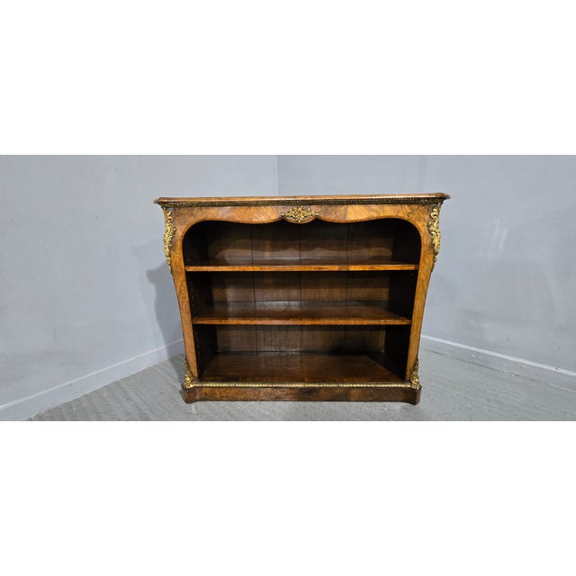 Superb quality English figured walnut concave sided and ormolu mounted open adjustable library bookcase, two adjustable...