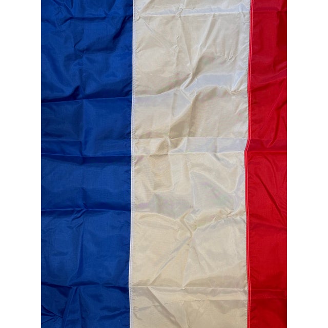 This is a late 20th century vintage flag. It is made of nylon. It represents France. It represents a blend of the...