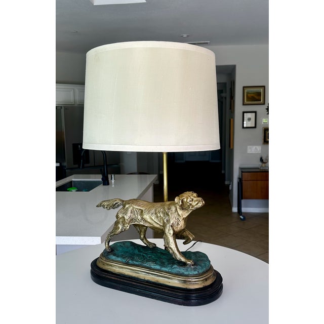 Vintage brass hunting dog figural table lamp featuring a setter or retriever dog sculpture on a dark wood base. Newly...