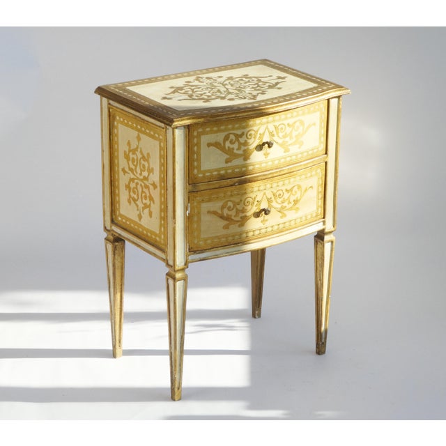 Vintage Florentine chest of drawers with unique gold and white coloured details. The table has two drawers with brass...