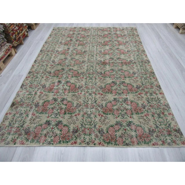 Vintage floral rug from the Oushak region of turkey. Approximately 50-60 years old. In good condition.