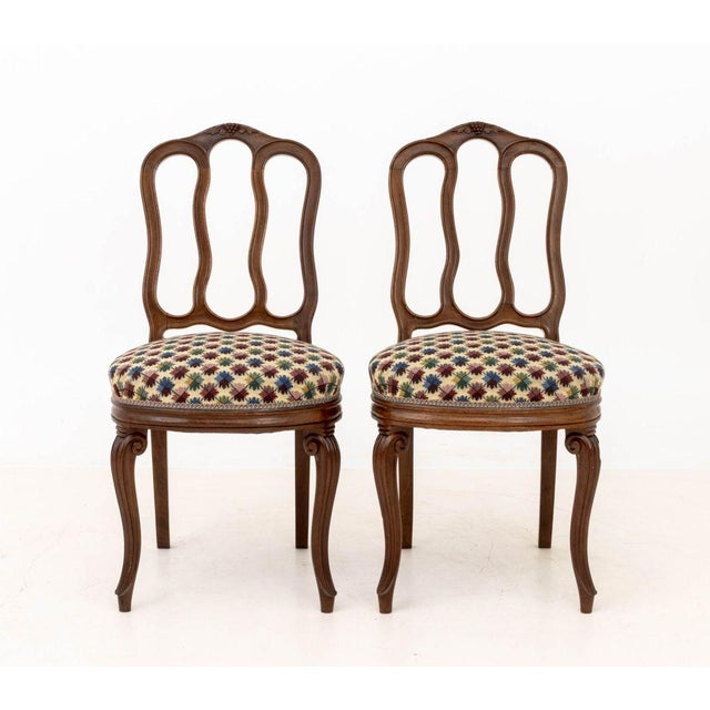 Pair of Louis XV Style Carved Walnut Side Chairs, with upholstered seats and carved grape bunch crestings. 35" H x 17" W x...