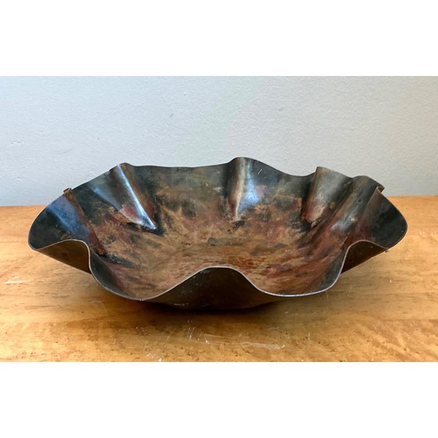This striking vintage scalloped decorative bowl is a refined example of mid-20th-century metalwork, distinguished by its...