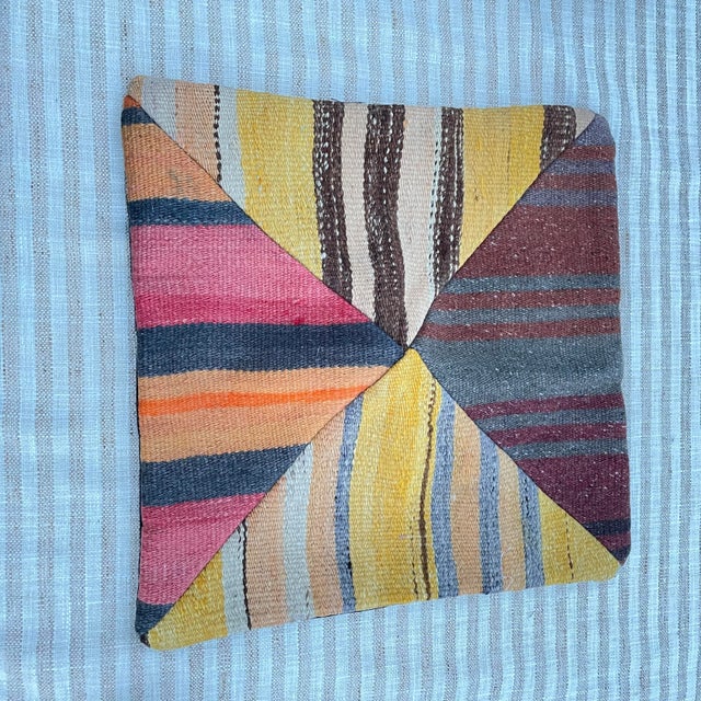 Quartered Kilim pillow with a stripe design and complementary colors. These are four pieces of rug(s) which have been sewn...