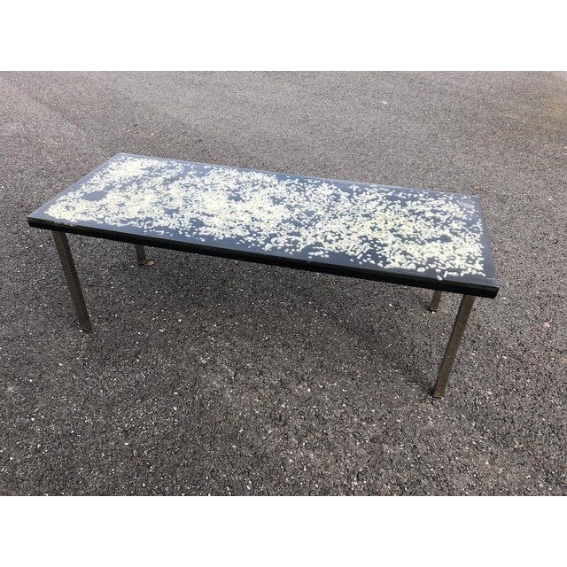 Rectangular resin table with inclusions on a metal base. A small mark on one corner, as shown in the photo. This piece is...