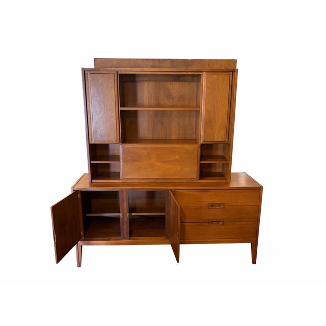 Here is a beautiful vintage Mid-Century Modern two-piece hutch and credenza by the United Furniture Company, featuring a...