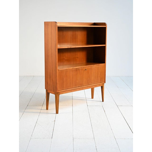 Teak bookcase with shelves and a closed lower compartment. Made by Bodafors, Sweden, 1950s. Produced by Bodafors, a...