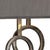 Scorched bronze finish on double iron circles with a natural brown marble base make a unique lamp for a bedside table or...