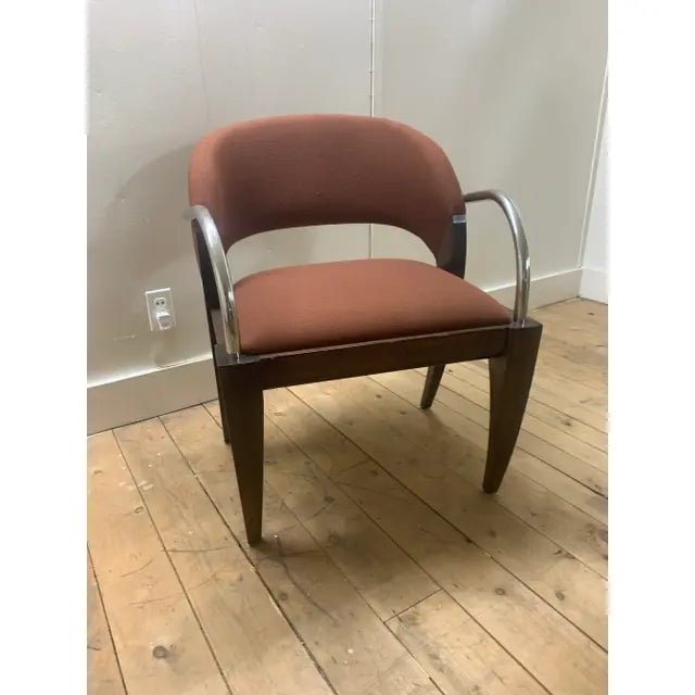 The Willow chair Attributed to Brueton is shown here in brown fabric with a black frame. The graceful curves of the...