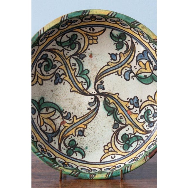 A 19th-century Moroccan pottery pastilla dish from Fez, c. 1830, decorated with swirling leaves and flowers in the Saz...