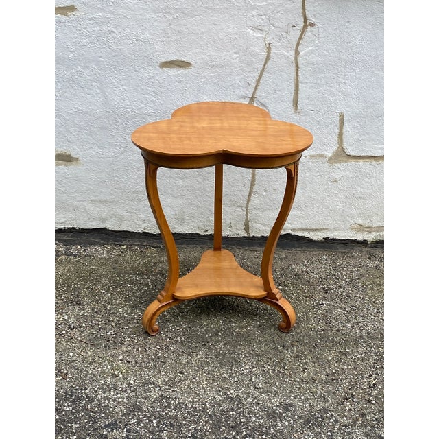 Beautiful light wood, clover shaped French table with ormolu accents. 2 tier. Very attractive, unusual piece of decor....