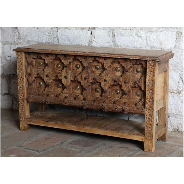 Crafted from a reclaimed antique door, this hand-carved console table carries the beauty of time in its naturally sun-...