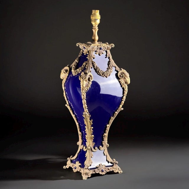 Luxurious french table lamp from the early 20th century, crafted in a sèvres-style deep cobalt glass and richly adorned...