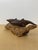 Hand carved Two dark brown wooden dolphins in a leaping pose, mounted on a piece of driftwood with a natural brown finish....