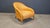 Timeless design armchair crafted from braided leather with wooden and metal legs. Designed by Antonio Citterio and...
